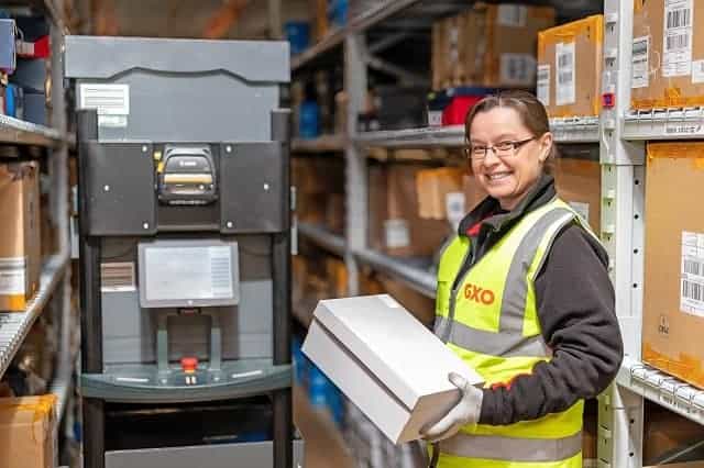 Warehouse associate working with autonomous mobile robot